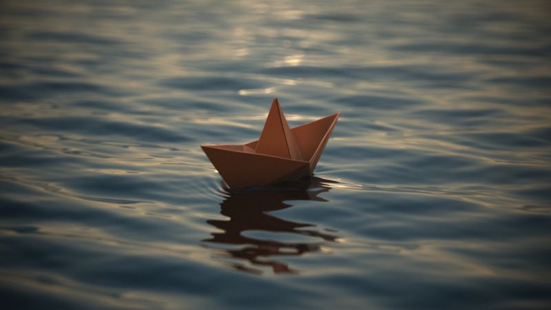 3d rendering of a paper boat on water